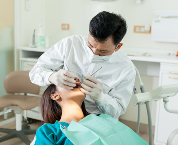 Dentist in Fort Lee building up a tooth for a dental crown