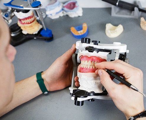 Lab technician creating a full denture