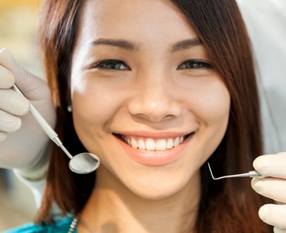 Patient in Fort Lee smiling after learning how to prevent dental emergencies