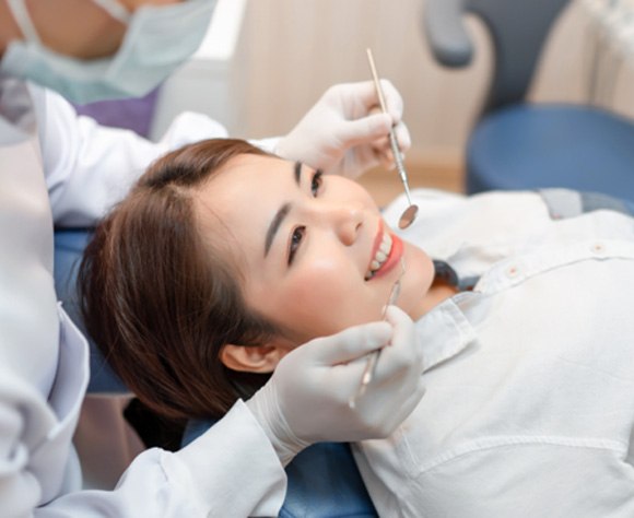 Dentist in Fort Lee examining patient during routine dental checkup 