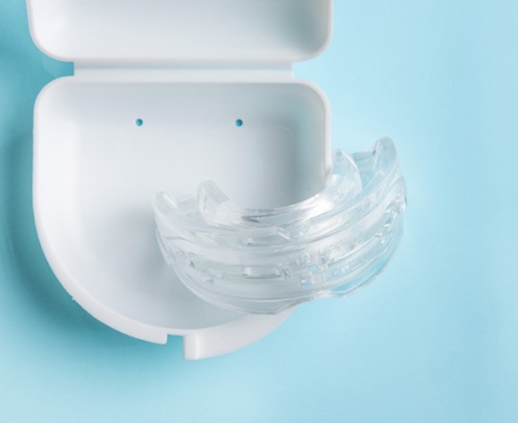 A custom mouthguard on a white surface for dental emergency prevention 