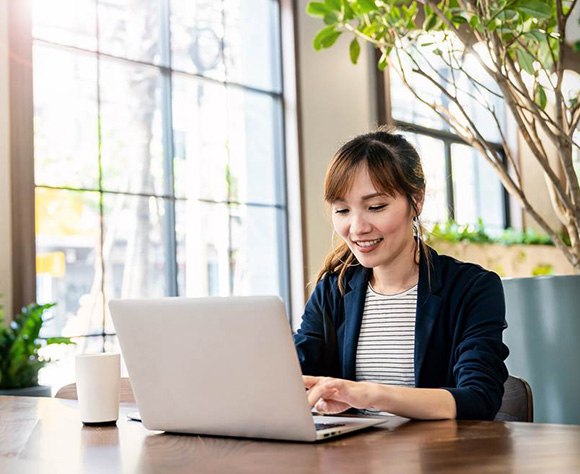 Patient scheduling an appointment with a female dentist in Fort Lee on a laptop