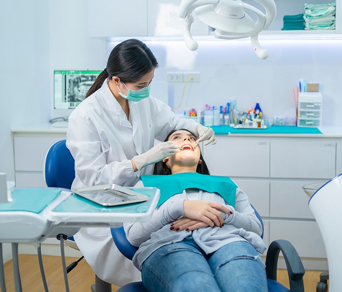 Female dentist in Fort Lee smiling with a patient