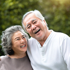 Older patient in Fort Lee smiling with natural-looking dental implants