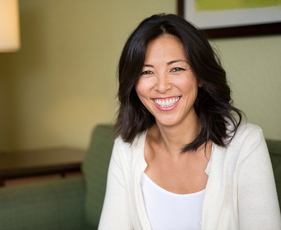 Patient in Fort Lee smiling confidently with dental implants