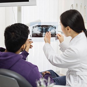Dentist in Fort Lee reviewing a cone beam scan with a patient