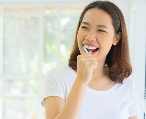 Fort Lee patient brushing teeth at home