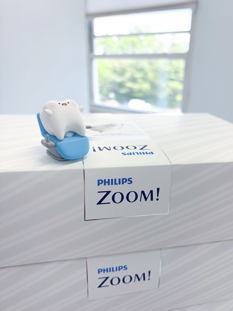 Philips Zoom! Teeth Whitening on desk with tooth mascot